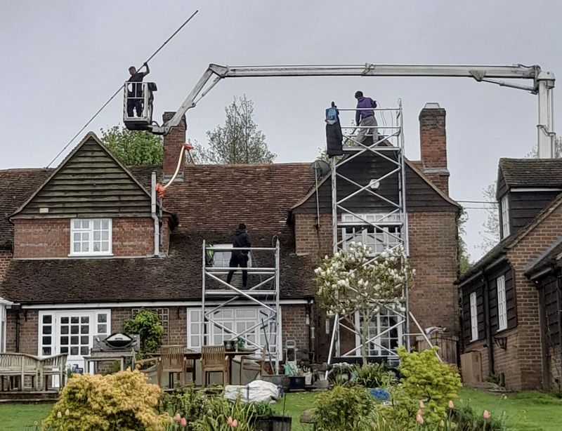 The Roof Moss Cleaners using cherry picker and scaffolding to clean roof safely and professionally in Arlesey, Bedfordshire